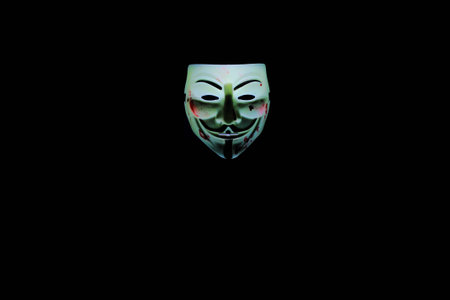 Dnipropetrovsk, Ukraine - February 05, 2016: Guy Fawkes mask, stained with red paint. Made with light paintingのeditorial素材