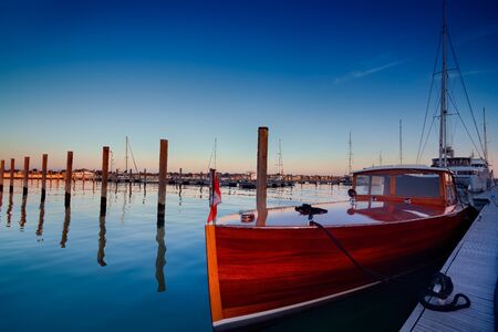 Classic mahogany luxury boat moored, Venice, Italy.の写真素材