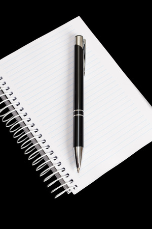 Pen and notepad on black backgroundの写真素材