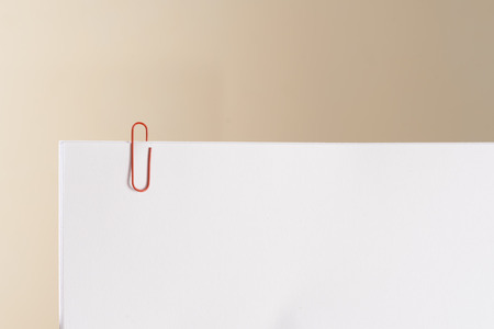 Some white papers clipped together. Represents reminders, documents or work papers.の写真素材