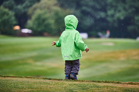 The boy walks the golf courseの写真素材