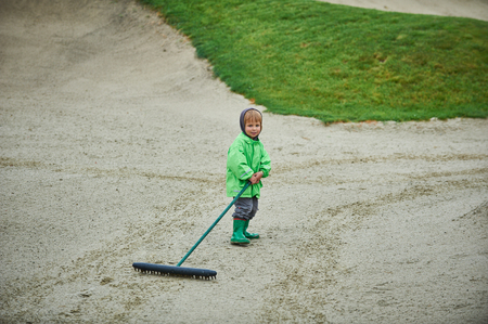 boy walking the golf courseの写真素材