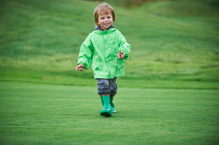 boy walking the golf courseの写真素材