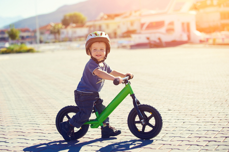 Little boy riding a runbikeの写真素材
