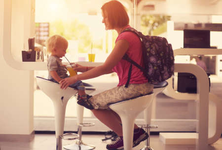 happy mother with a child in a cafeの写真素材