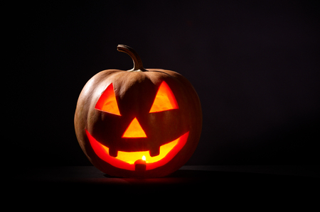 Kind Halloween Pumpkin On A Black Backgroundの写真素材