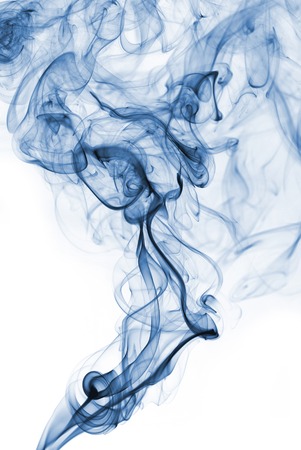 Blue abstract smoke from the aromatic sticks on a white background.の写真素材