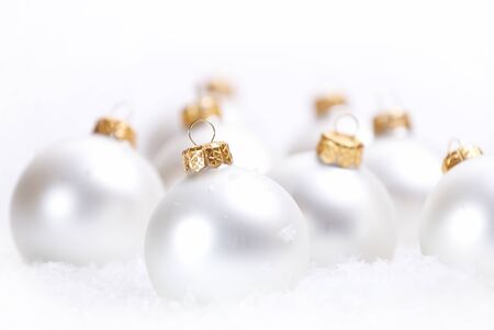 Christmas beautiful white balls with snow on white backgroundの写真素材