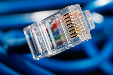 LAN network connection blue cable on black backgroundの写真素材