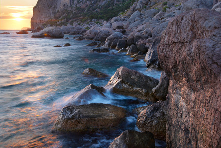 Colorful summer seascape. rocky coast at sunsetの写真素材