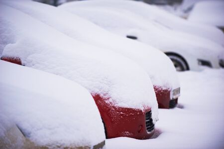 Cars covered with snow in the parking.の写真素材