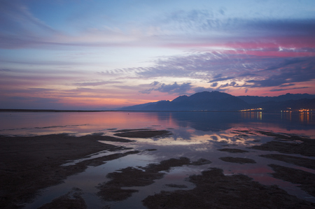 Sunset over a beach during low tideの写真素材
