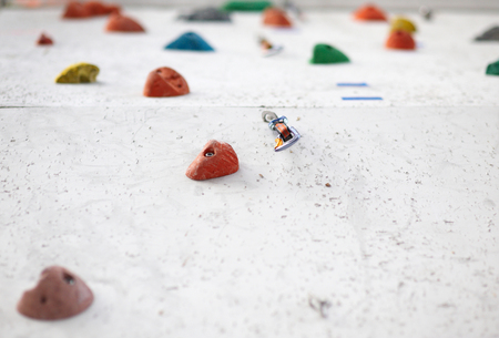 Grey wall with climbing holds in gymの写真素材