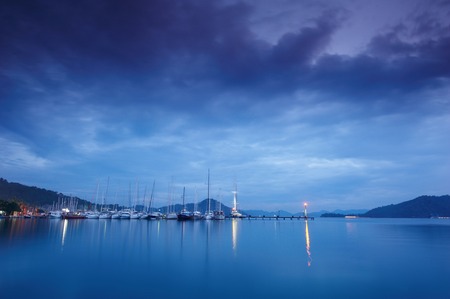 Marina at night with moored yachtsの写真素材