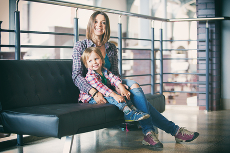 Beautiful mother sitting with her cute sonの写真素材
