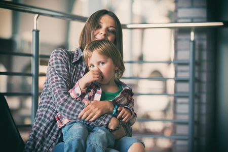 Beautiful mother sitting with her cute sonの写真素材