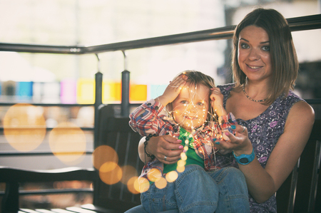 Beautiful mother sitting with her cute sonの写真素材