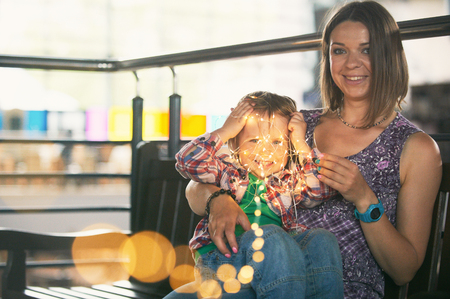 Beautiful mother sitting with her cute sonの写真素材