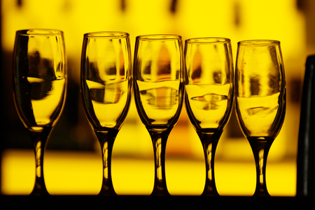 Empty glasses on table in night clubの写真素材