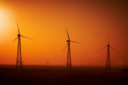 Wind power generation, Wind turbines on farmland with sunsetの写真素材