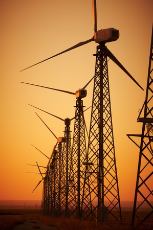Wind power generation, Wind turbines on farmland with sunsetの写真素材
