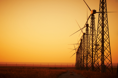 Wind power generation, Wind turbines on farmland with sunsetの写真素材