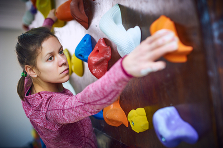sporty woman in boulder climbing hallの写真素材
