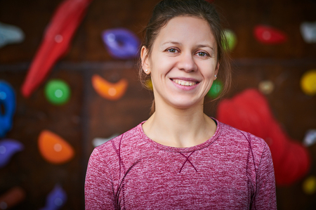 sporty woman in boulder climbing hallの写真素材
