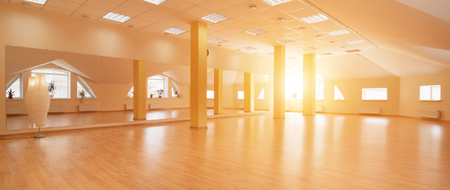 Perspective view of empty sunny yoga studio with wooden flooringの写真素材