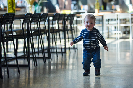 Cute toddler walking in the shopping center.の写真素材