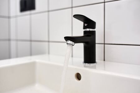 working water tap in the modern bathroom.の写真素材
