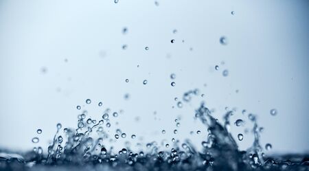abstract falling drops of water on a light background close-up.の写真素材