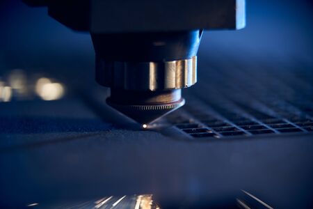 CNC Laser cutting of metal close up, modern industrial technology. Small depth of field.