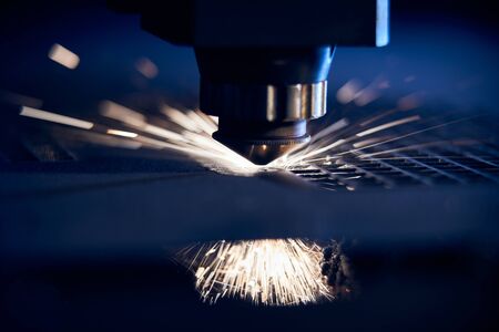 CNC Laser cutting of metal close up, modern industrial technology. Small depth of field.の写真素材