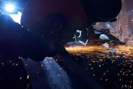Metal sawing. Hot sparks at grinding steel material