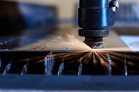 CNC Laser cutting of metal close up, modern industrial technology. Small depth of field.