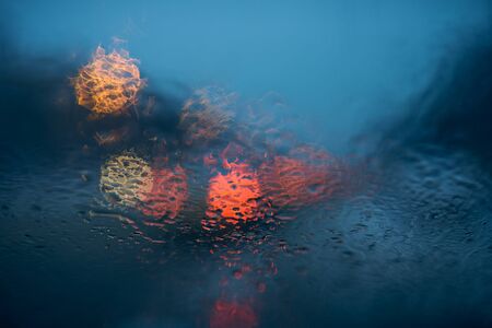 Drops Of Rain On Windshield. Street Bokeh Lights Out Of Focus.