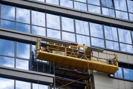 Scaffold elevator insulated wall facade with mineral wool. Modern office or residential building...