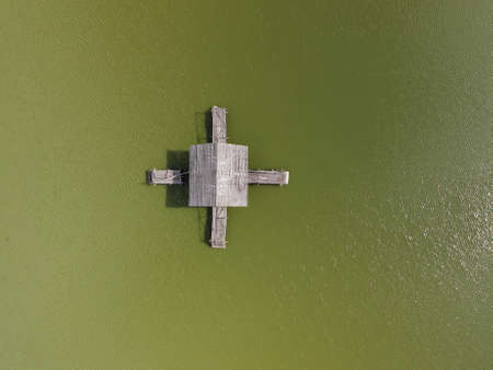 Aerial view of old wooden fisherman house on the lake. Beautiful landscape with house on the lake. Top view.の写真素材