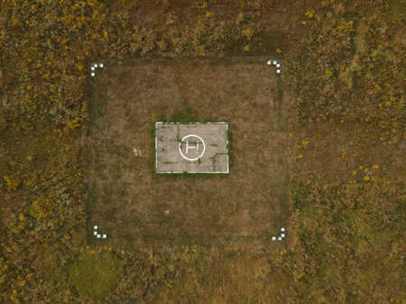 helicopter landing place in the field at summer day, aerial view.