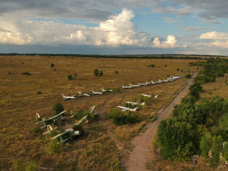 Old abandoned airfield with abandoned planes. Aerial top view.