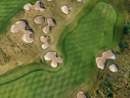 Aerial view of the green grass of the golf course. Top view.