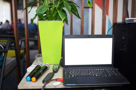 Blank screen laptop computer on the Abstract blurred photo of conference hall or seminar room with attendee background.の写真素材