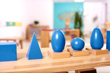 Light class in Montessori kindergarten. The blue Montessori geometric solids in the foreground. nobody.の写真素材