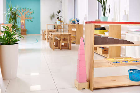Light class in Montessori kindergarten. The pink tower is in the foreground. nobody.