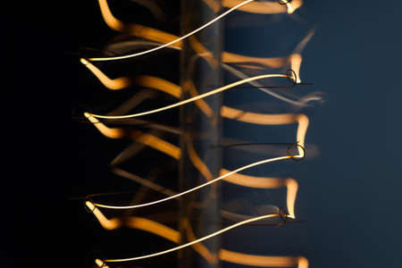 Electric vintage Edison light bulb with a spiral on a blue background. Retro style lamp.の写真素材