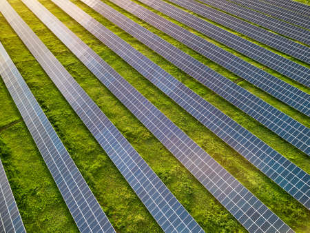 Aerial view of solar power plant in green meadow at sunny day.の写真素材