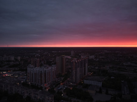 the city of kharkiv against the background of a red sunset sky aerial drone viewの写真素材