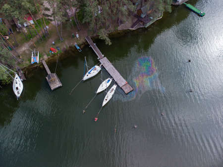 Aerial top view of a water pollution. Oil stain on the water from the yacht. Environmental disaster.