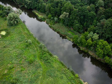 Aerial view over the river which is on the green forest. drone photoの写真素材